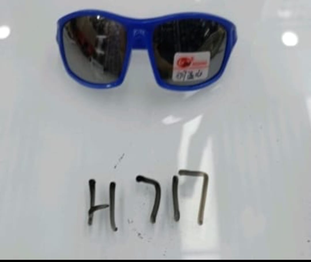 Blue sunglasses with a visible brand logo on a white surface, with numbers 'H717' written below.