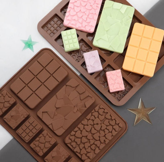 Chocolate molds with various shapes on a gray surface