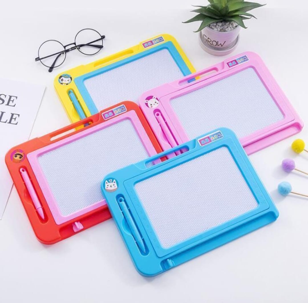 Colorful drawing boards on a white surface with glasses and a plant in the background.