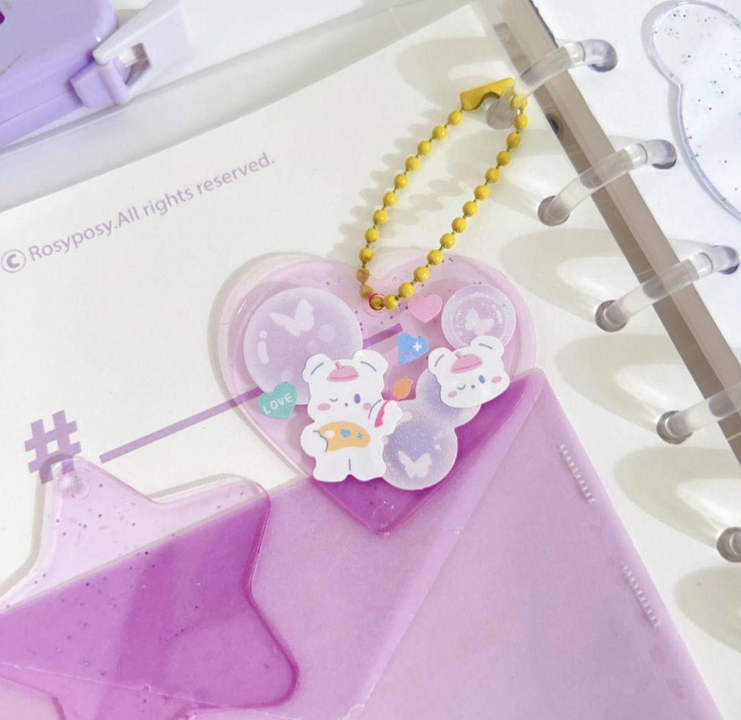 Heart-shaped planner charm with cartoon character on a planner page
