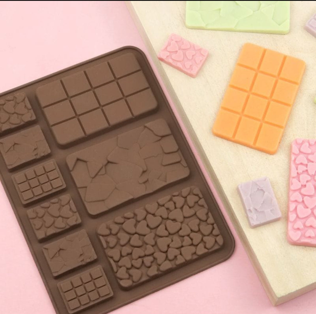 Silicone mold for chocolate with various shapes on a pink background