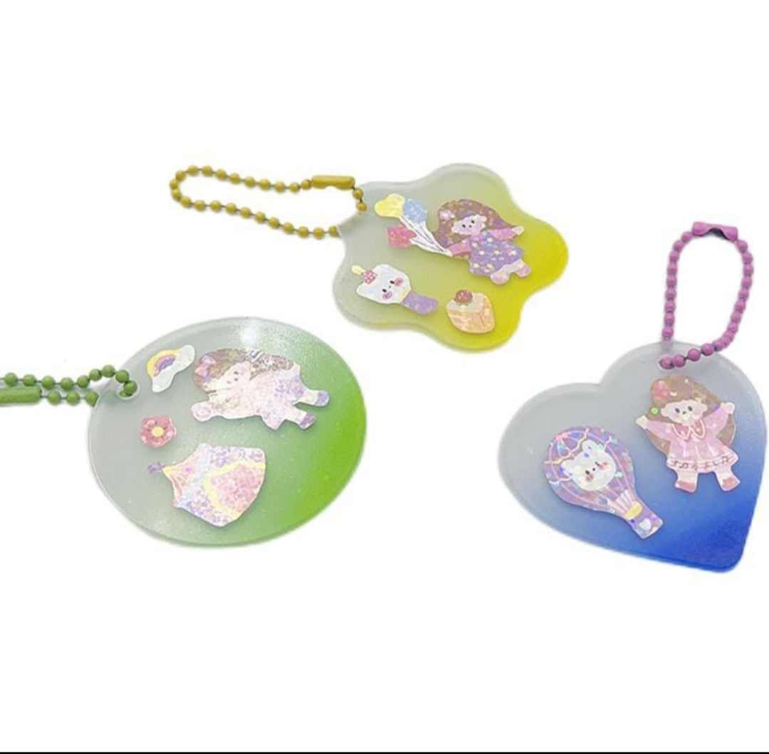 Three colorful keychains with cartoon characters on a white background