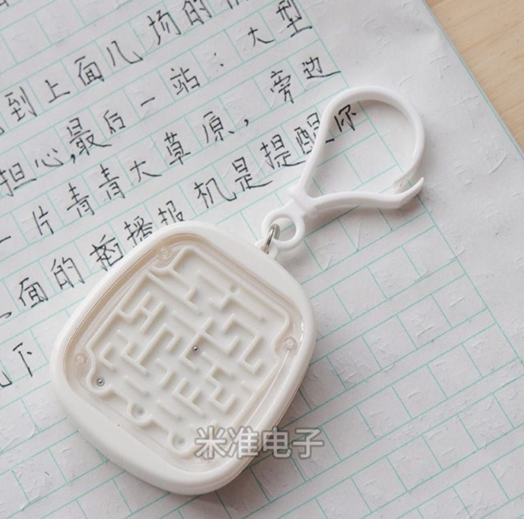White maze-shaped object on a piece of paper with text