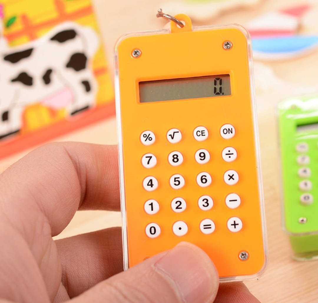 Orange calculator held by a hand with a colorful background