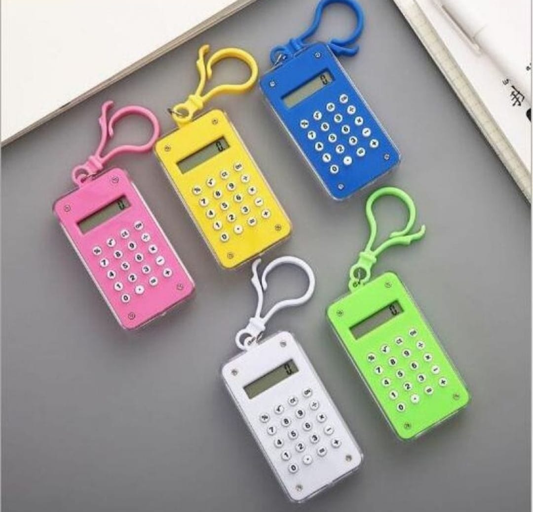 Five colorful calculator keychains on a gray surface