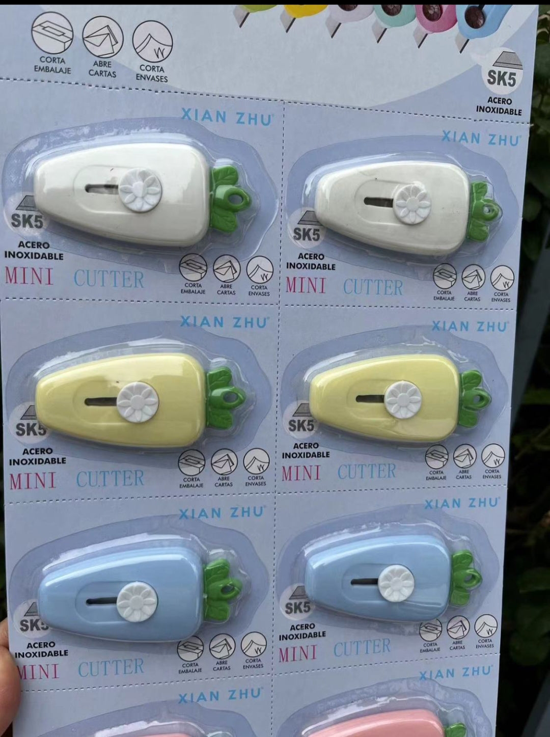Packaging of Xian Zhu mini cutters in various colors on a white background.