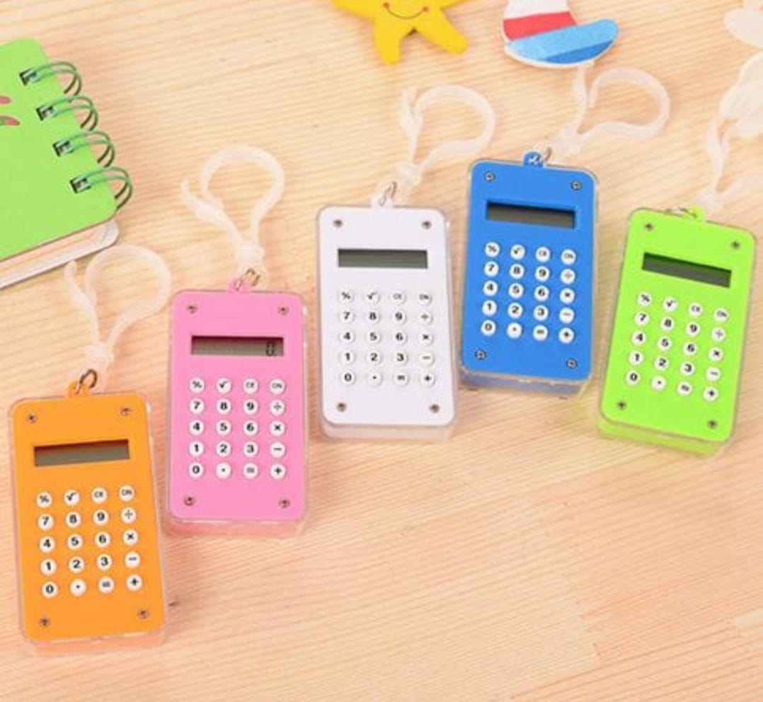 Colorful calculator keychains on a wooden surface