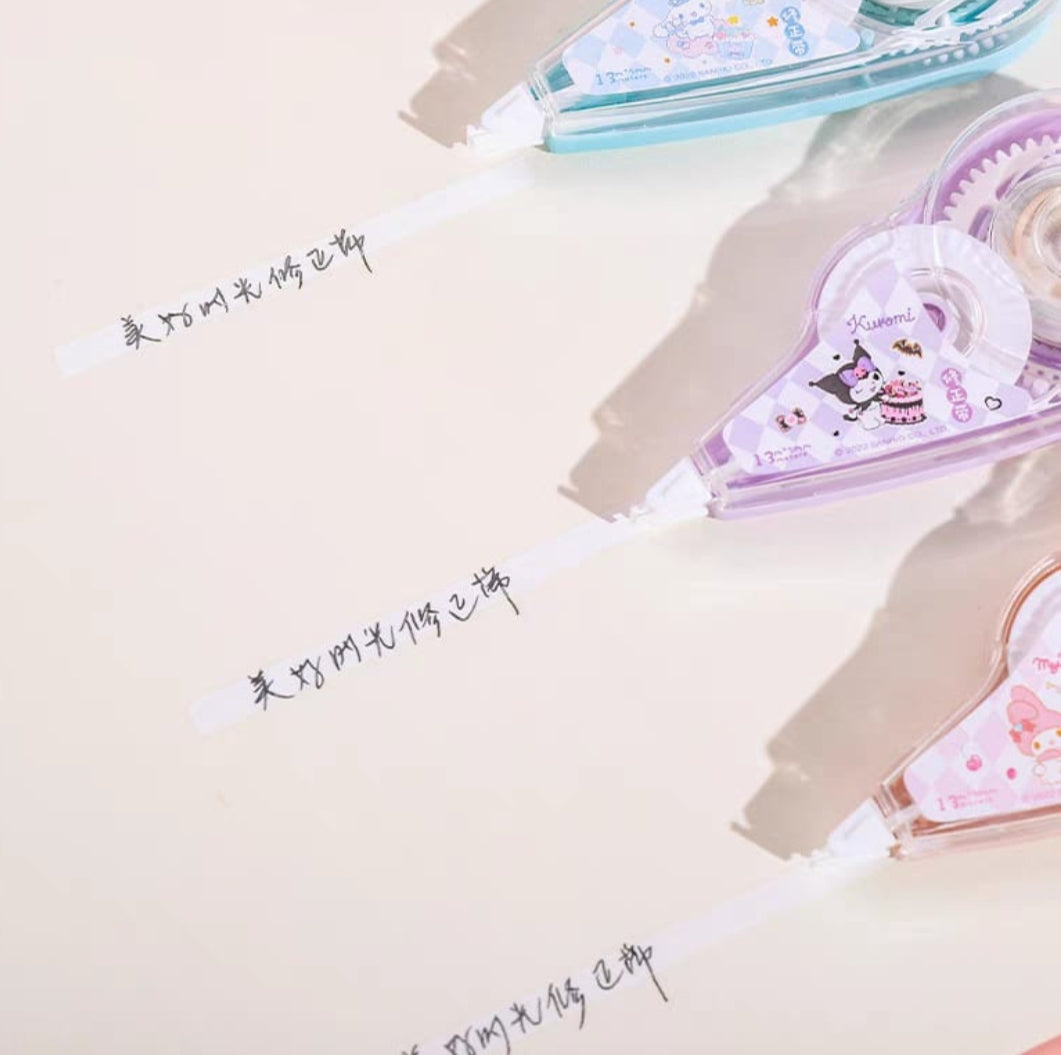 Stationery items including a pink notebook, pen, and decorative tape on a light background.