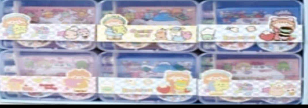 Set of small plastic containers with cartoon character labels on a white background