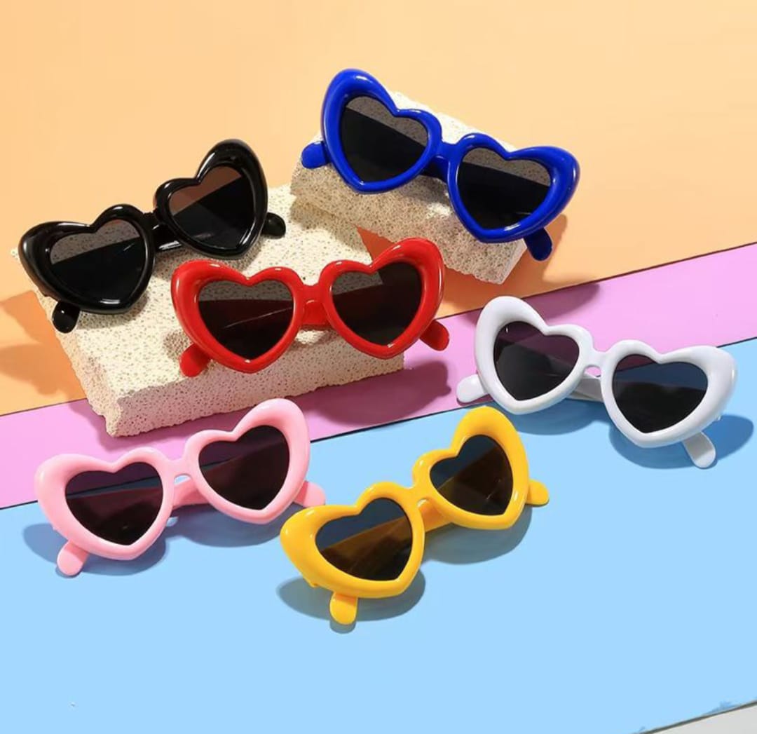 Heart-shaped sunglasses in various colors on a colorful background