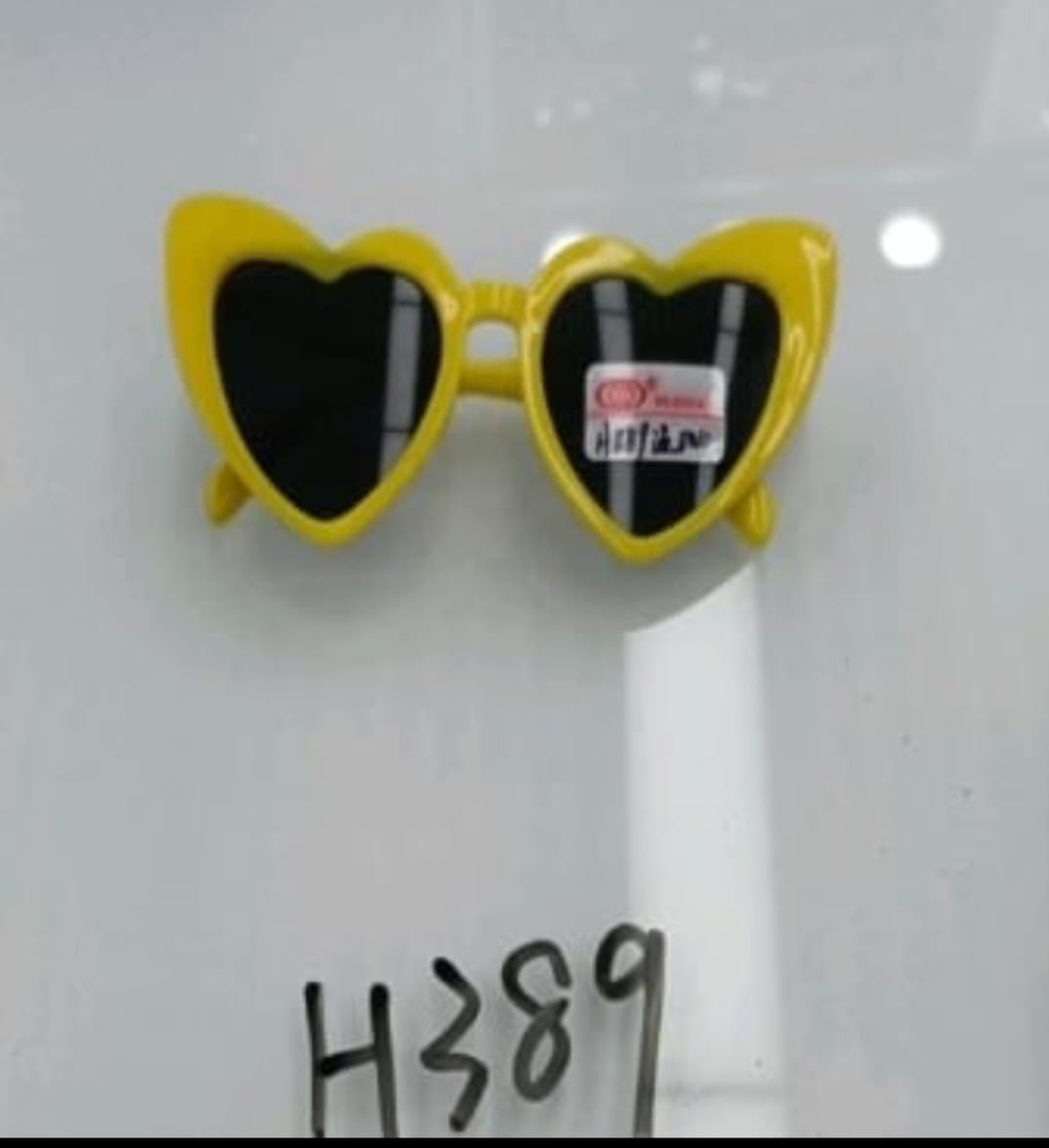 Heart-shaped yellow sunglasses with black lenses on a white background