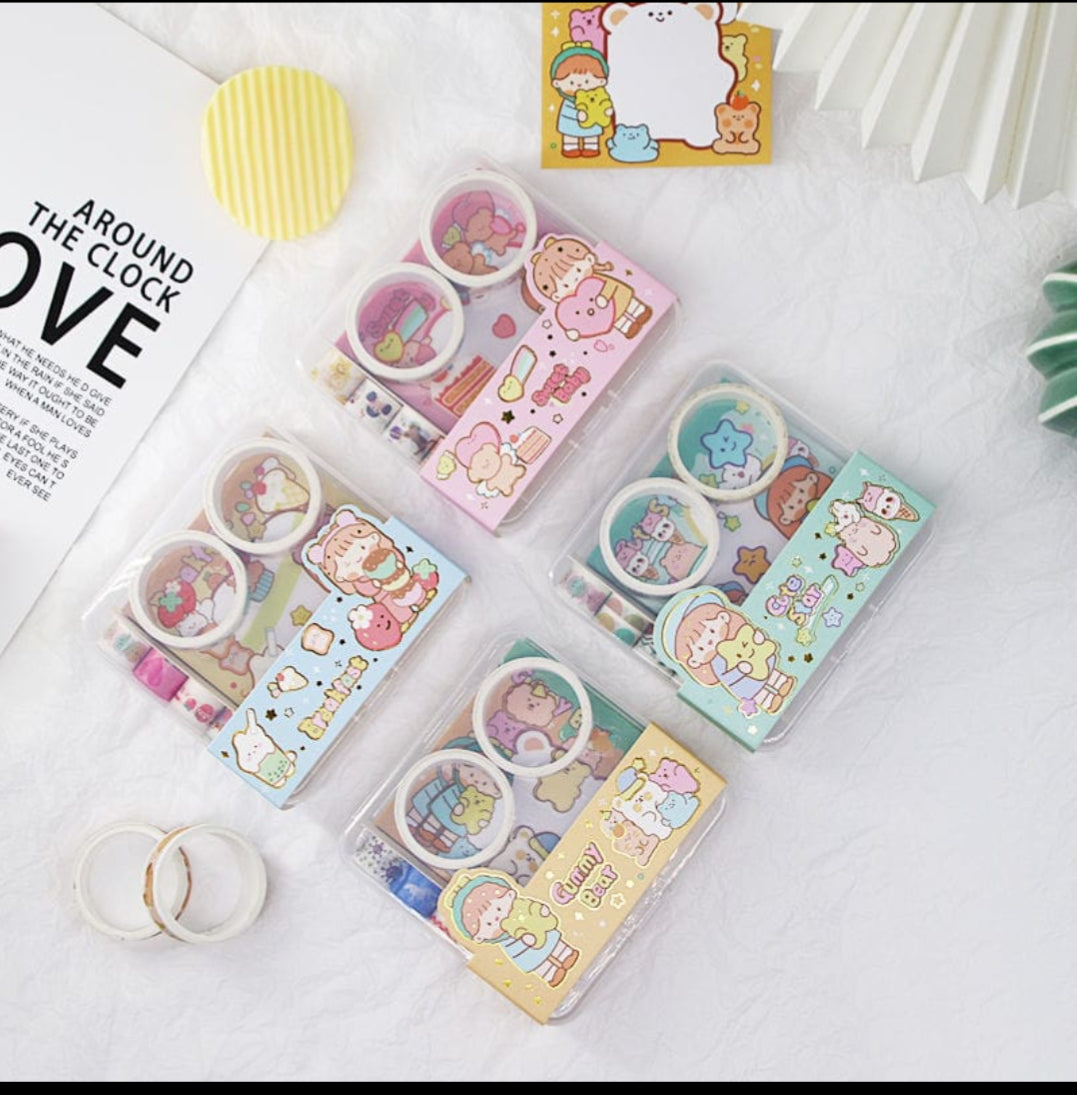 Set of colorful stationery items with cartoon designs on a white surface.