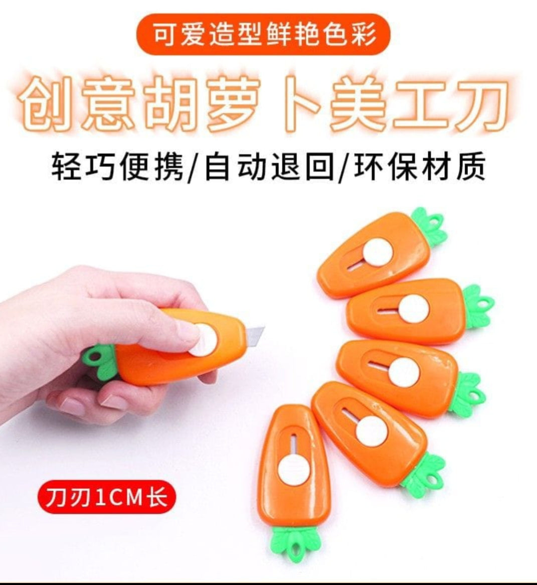 Carrot-shaped art knife with a hand holding it, surrounded by additional knives on a white background.